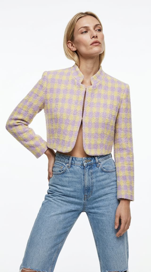 An AI fashion model wearing the tweed jacket with jeans