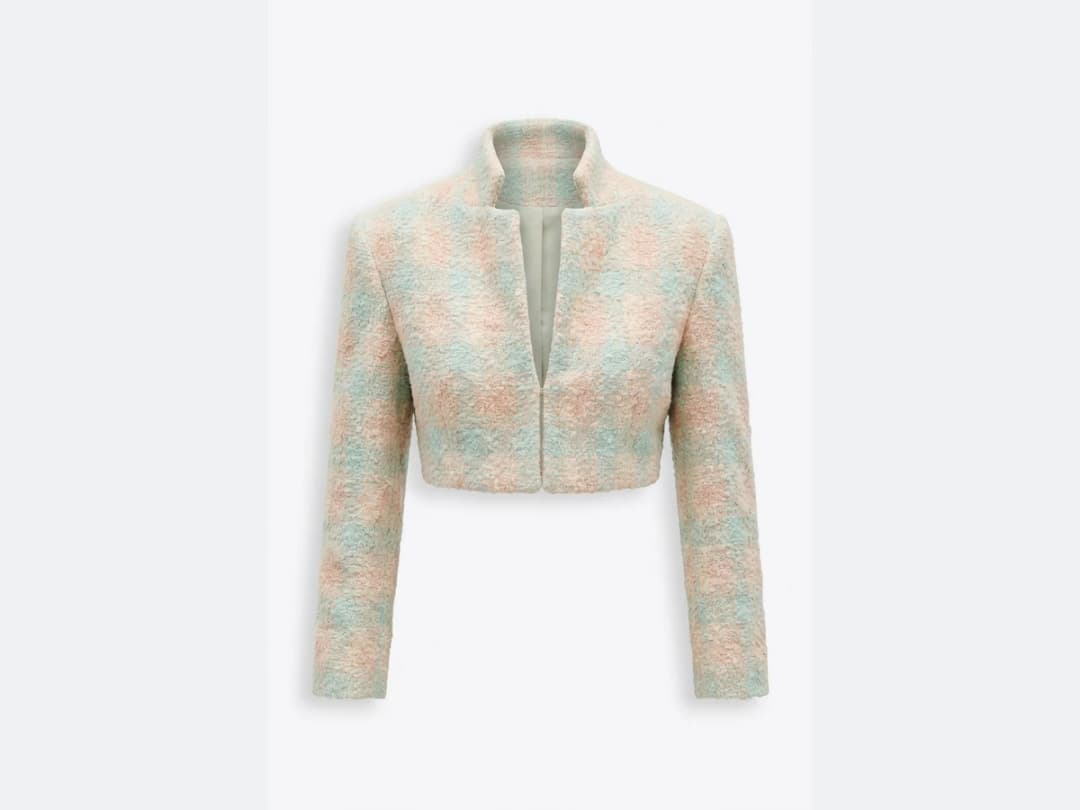 A pastel tweed cropped jacket photographed flat, the product the model is built from