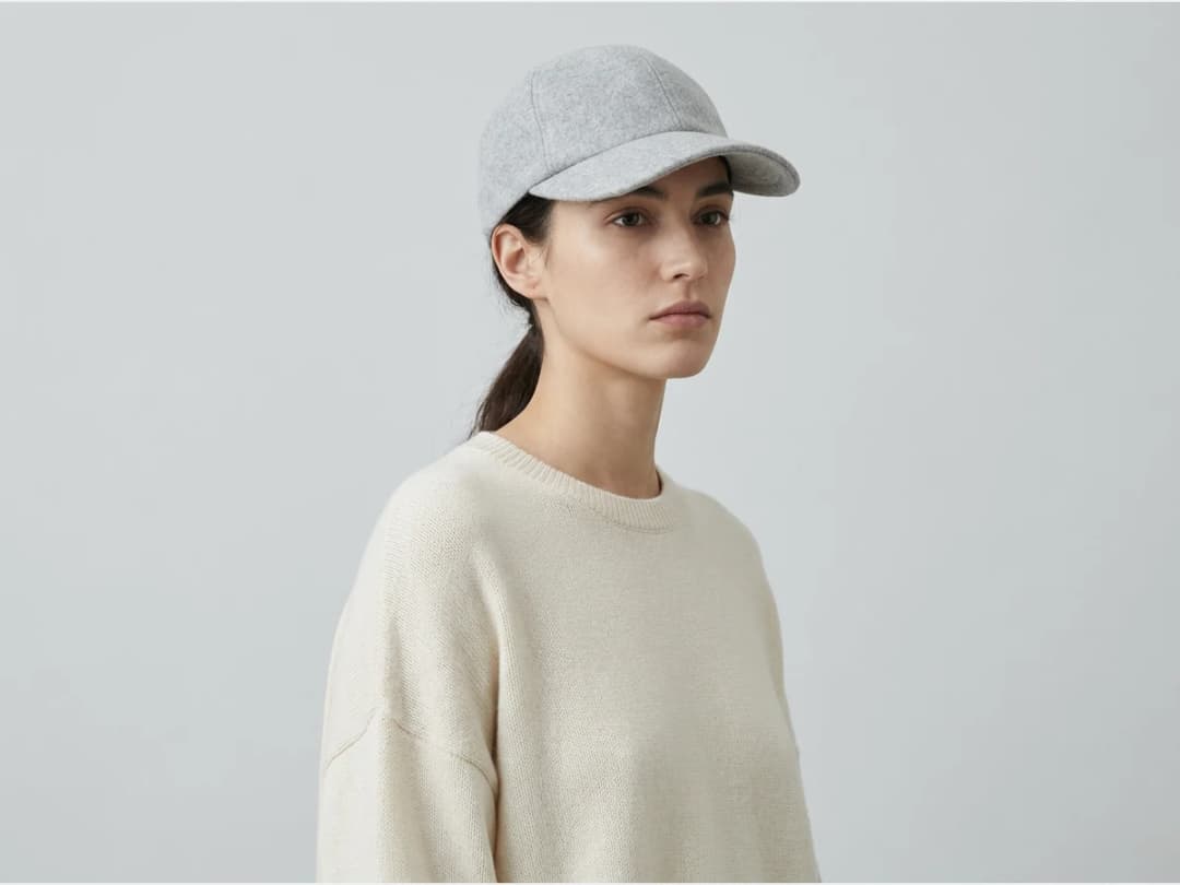 a model wearing a head accessory, a baseball cap