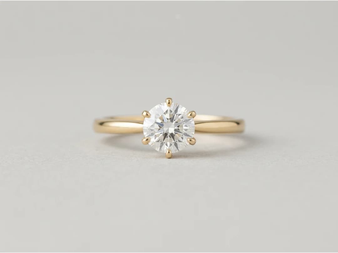 a fine gold ring set with a single stone, product shot, front view, centred