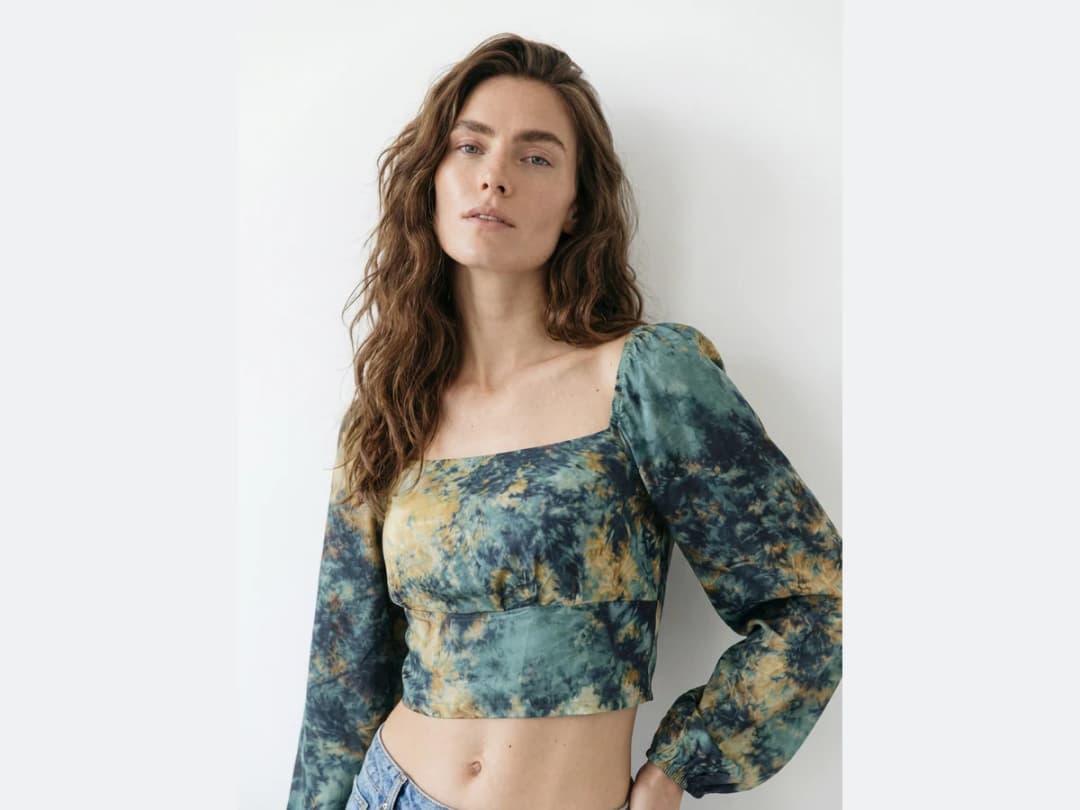 A model photographed wearing a tie dye cropped top, the image the fabric is swapped on
