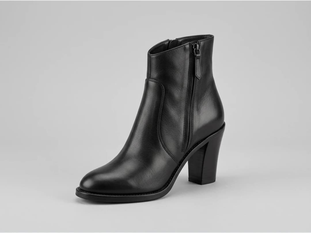 a designer shoe, product shot, a leather ankle boot, three quarter view