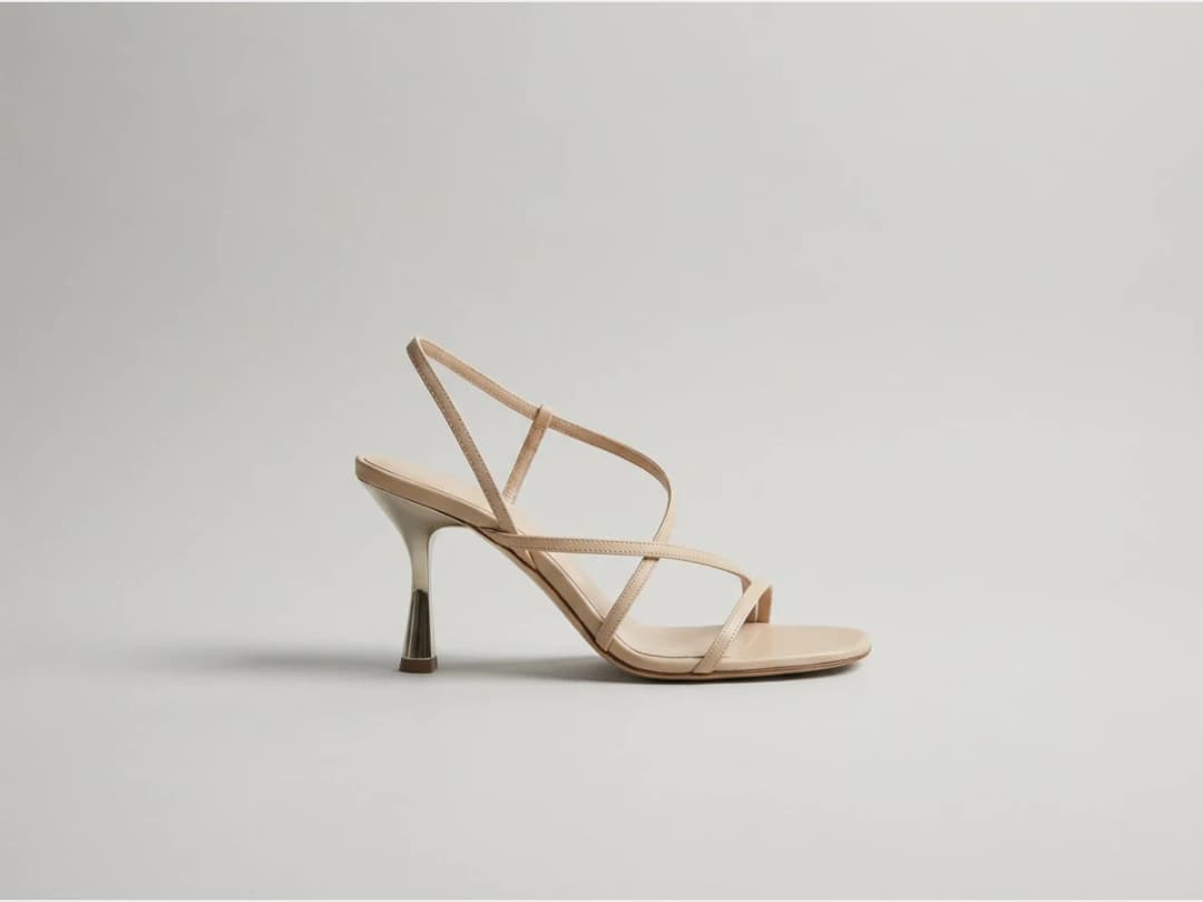a designer shoe, product shot, a strappy heeled sandal