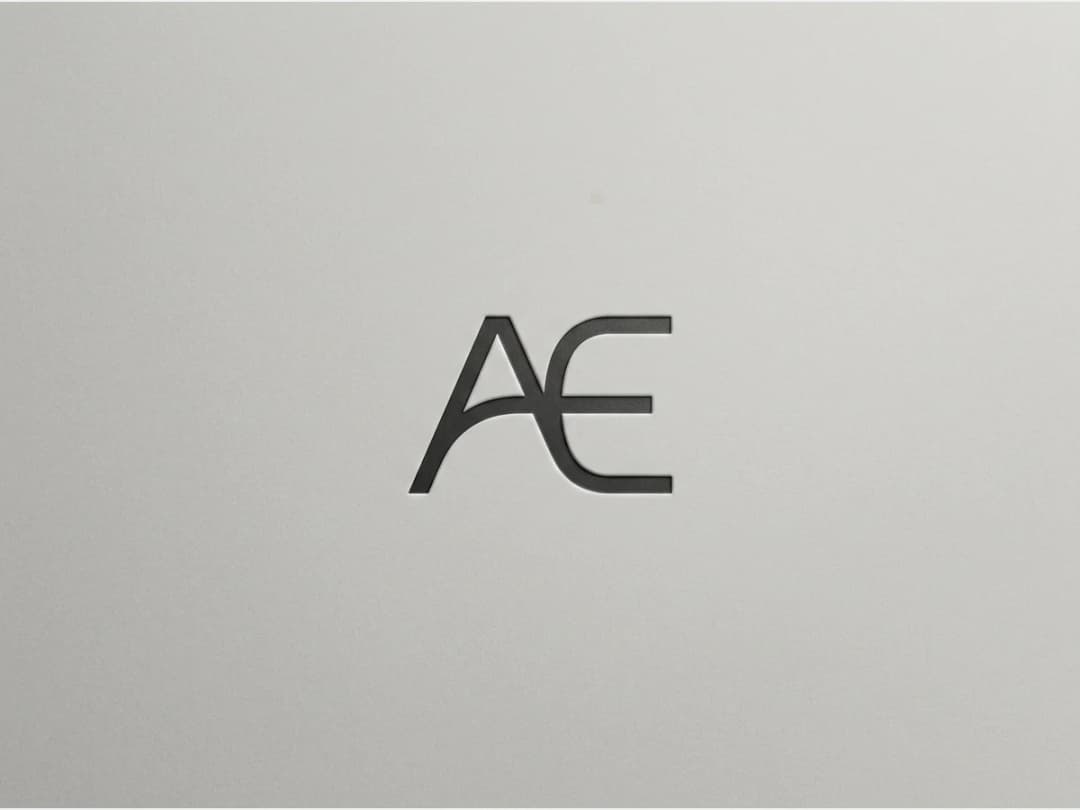a fashion brand logotype on a plain ground, a minimal monogram