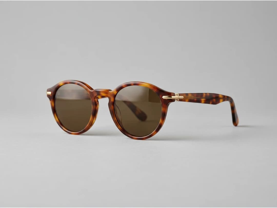 a pair of sunglasses, product shot, round tortoiseshell frames